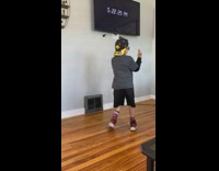 Boy spins in circles while sister pretends to play piano