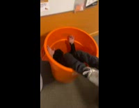Guy gets thrown into orange bucket