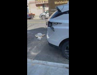 white car has red graffiti and is damages