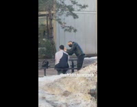Guy cuts hair outside on picnic table 