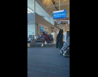 Lady takes selfies at airport 