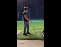 Guy hits golf ball far at topgolf 