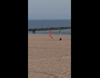 Man in red underwear pole dance on the beach