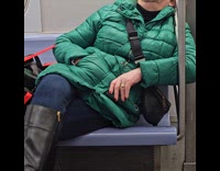 Woman green jacket falls asleep at subway