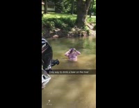 Guy catches and shotguns beer in river 