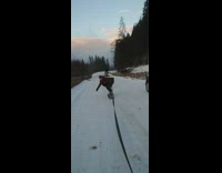 Guy on snowboard gets pulled by car