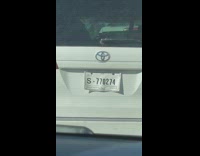 White SUV paper license plate attached behind