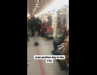 Two guys play electric guitar and violin on subway train