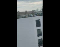 Guy films tiktok dance rooftop ring light 