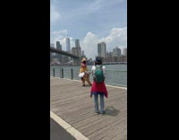 Dinosaur costume with a skirt dances on the dock