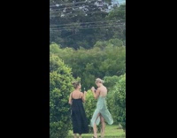 Girl black dress blow dandelion small trees