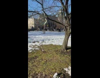 Guy with postmates bag walks barefoot park 