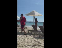 Woman bikini fixed pose under umbrella beach