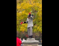 Man standing holds speaker plays random noise 