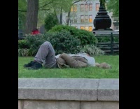 Guy Lays on Grass next to Squirrel