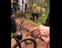 Guy riding blue bicycle falls during race 