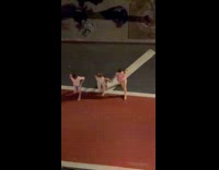 Three people in swimwear dances at street