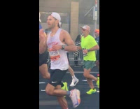 Guys holds funny marathon sign for friend