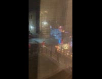 Woman sexy Santa lit hula-hoop on sidewalk