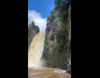 Collab SendItOfficiall - Man shirtless flip jump on muddy waterfalls