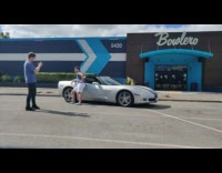 Man lean sports car Bowlero parking lot