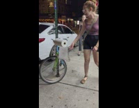 Woman take toilet paper on bike handle