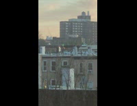 Guy spins twirls fire outside on rooftop 
