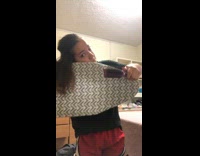 Girl using ironing board to straighten hair