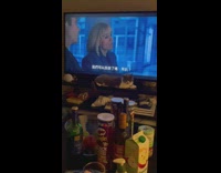 (3RD PARTY CONTENT) One cat by television other sleeping on chair 