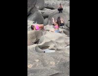 Woman pink bikini lie down on rocks