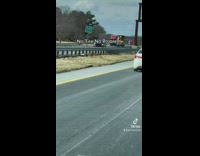 White car driving on the freeway at high speed with no rear tire