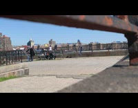 Kid Bounces on Pogo Stick while Kids Scooter
