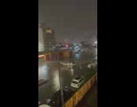Car makes wave driving through flood 