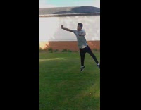 Guy does a side frontflip and lands on his head in the grass, slow motion