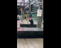 Man red hair live streams at airport