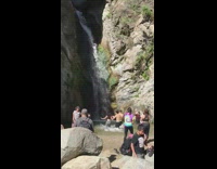 Three people scream towards waterfalls public