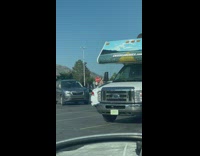 Woman with car parked sideways parking lot