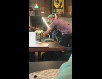 Purple shirt guy camera photographs food restaurant 