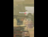 Washer dryer machine on fire at laundromat, firefighters come and distinguish fire