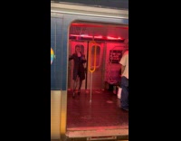 Woman dance to music inside the train