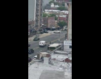 Guy rides on tall unicycle down sidewalk 