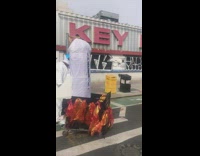 People in astronaut costumes with white object on wagon