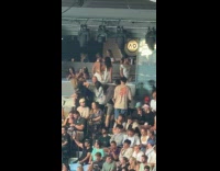Women poses at corporate box of stadium