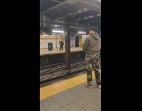 Guy throw donut to girl across subway station