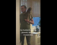 Guy in green shirt holding dog 