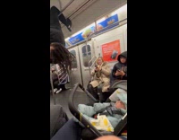 Guy hang on train metal bars near baby