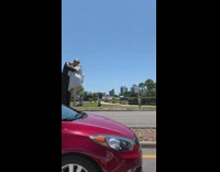 Guy large sailor kissing statue red car