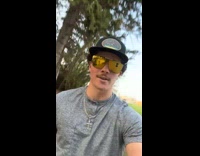 Guy with group of chickens following him 