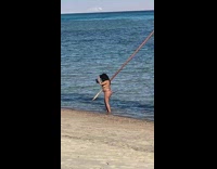 Woman brown bikini selfie beach metal triangle