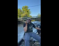 Guy shotguns beer can bridge motorboat lake 
